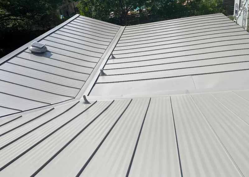 Solar attic fan installed on a metal roof for Roof Ventilation in Willow Springs