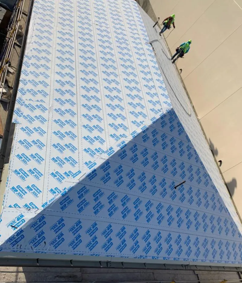 Professional roofers installing underlayment on a metal roof in Willow Springs